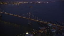 5K aerial stock footage approach and tilt to the Bay Bridge from Downtown San Francisco, California, night Aerial Stock Footage | AXSF10_099