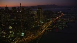 5K aerial stock footage tilt from heavy traffic on the Bay Bridge, reveal Downtown San Francisco, California, twilight Aerial Stock Footage | AXSF10_109