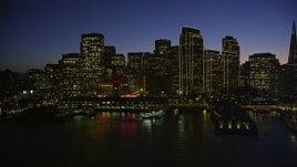 5K aerial stock footage of the Ferry Building and towering skyscrapers in Downtown San Francisco, California, night Aerial Stock Footage | AXSF10_114