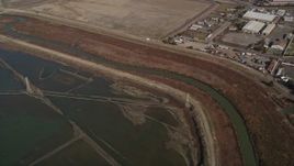 5K aerial stock footage flyby power lines and marshland, reveal water treatment plant, Union City, California Aerial Stock Footage | AXSF11_006