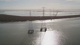 5K aerial stock footage tilt from marshland and follow power lines through wetlands, Sunnyvale, California Aerial Stock Footage | AXSF11_025