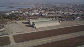 5K aerial stock footage tilt from a parked jet to reveal and approach Hangar Two and Three, Moffett Field, Mountain View, California Aerial Stock Footage | AXSF11_052