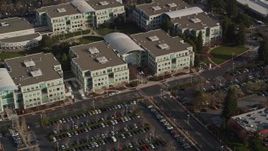 5K aerial stock footage of tilting from homes to reveal Apple Headquarters office buildings, Cupertino, California Aerial Stock Footage | AXSF12_034