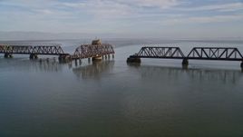 5K  aerial stock footage tilt from the bay to reveal and flyby the Dumbarton Rail Bridge in San Francisco Bay, California Aerial Stock Footage | AXSF12_066