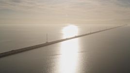 5K aerial stock footage of flying by San Mateo Bridge, sun reflecting off San Francisco Bay, California Aerial Stock Footage | AXSF12_081