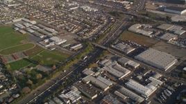 5K aerial stock footage reverse view of I-880, John Muir Middle School, and warehouse buildings in San Leandro, California Aerial Stock Footage | AXSF12_088