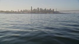 5K aerial stock footage fly low over the bay, tilt to reveal Downtown San Francisco skyline, California Aerial Stock Footage | AXSF13_005