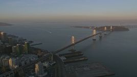 5K aerial stock footage of flying by the Bay Bridge and Downtown San Francisco, California, sunset Aerial Stock Footage | AXSF14_002