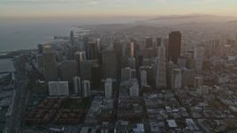 5K aerial stock footage approach city skyscrapers, tilt to city streets below in Downtown San Francisco, California, sunset Aerial Stock Footage | AXSF14_014