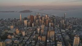 5K aerial stock footage of flying away from city buildings and skyscrapers in Downtown San Francisco, California, sunset Aerial Stock Footage | AXSF14_018