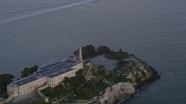 5K aerial stock footage of the main buildings and lighthouse on Alcatraz island, San Francisco, California, twilight Aerial Stock Footage | AXSF14_036