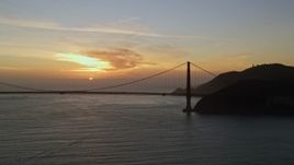 5K aerial stock footage Golden Gate Bridge with setting sun in the distance, San Francisco, California, sunset Aerial Stock Footage | AXSF14_039
