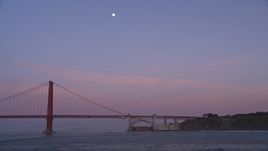 5K aerial stock footage of flying by Golden Gate Bridge with the moon in the sky, San Francisco, California, twilight Aerial Stock Footage | AXSF14_048