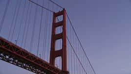 5K aerial stock footage fly low and tilt up to a tower of the Golden Gate Bridge, San Francisco, California, twilight Aerial Stock Footage | AXSF14_055
