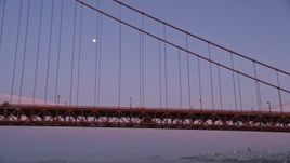 5K aerial stock footage of flying by the Golden Gate Bridge with a view of the moon, San Francisco, California, twilight Aerial Stock Footage | AXSF14_056