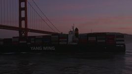 5K aerial stock footage orbit cargo ship and reveal Golden Gate Bridge, San Francisco, California, twilight Aerial Stock Footage | AXSF14_064