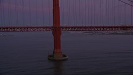 5K aerial stock footage flyby the base of a tower of the Golden Gate Bridge, San Francisco, California, twilight Aerial Stock Footage | AXSF14_065