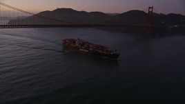 5K aerial stock footage fly over Golden Gate Bridge, reveal cargo ship, San Francisco, California, twilight Aerial Stock Footage | AXSF14_066