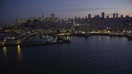 5K aerial stock footage flyby Fisherman's Wharf, downtown skyline in the background, reveal Pier 39, San Francisco, California, twilight Aerial Stock Footage | AXSF14_088