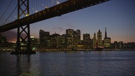 5K aerial stock footage of city skyscrapers, revealing Bay Bridge, Downtown San Francisco, California, twilight Aerial Stock Footage | AXSF14_104
