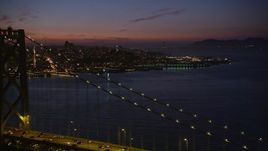 5K aerial stock footage of flying over Bay Bridge while focusing on Coit Tower, North Beach, San Francisco, California, twilight Aerial Stock Footage | AXSF14_114