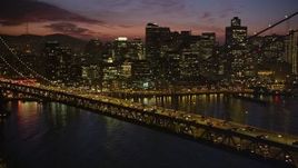 5K aerial stock footage of heavy traffic on upper deck of Bay Bridge, revealing Downtown San Francisco skyscrapers, California, twilight Aerial Stock Footage | AXSF14_116