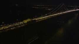 5K aerial stock footage flying by heavy traffic on the Bay Bridge, San Francisco, California, night Aerial Stock Footage | AXSF14_123