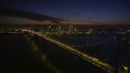 5K aerial stock footage descend near Bay Bridge, with views of skyscrapers in Downtown San Francisco, California, night Aerial Stock Footage | AXSF14_126