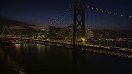 5K aerial stock footage flying by the Bay Bridge with the skyline in background, Downtown San Francisco, California, night Aerial Stock Footage | AXSF14_127
