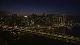 5K aerial stock footage of passing by Bay Bridge, with views of Downtown San Francisco skyscrapers, California, night Aerial Stock Footage | AXSF14_128