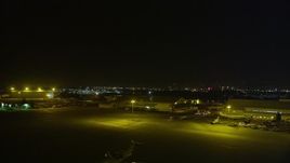 5K aerial stock footage a view of hangars while descending at Oakland International Airport, California, night Aerial Stock Footage | AXSF14_137