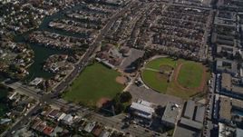 5K aerial stock footage of a reverse view of suburban neighborhoods and baseball fields, Alameda, California Aerial Stock Footage | AXSF15_002