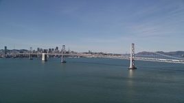 5K aerial stock footage of approaching the Bay Bridge, with views of Downtown San Francisco behind it, California Aerial Stock Footage | AXSF15_004