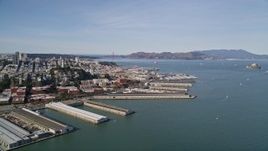 5K aerial stock footage flyby Coit Tower and North Beach piers, view of Golden Gate Bridge, San Francisco, California Aerial Stock Footage | AXSF15_010