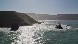 5K aerial stock footage of tilting from the ocean revealing coastal cliffs and rock formations, Pacifica, California Aerial Stock Footage | AXSF15_040