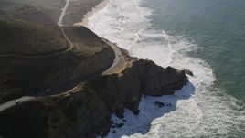 5K aerial stock footage video of following Highway 1 along the coast, winding above cliffs, Montara, California Aerial Stock Footage | AXSF15_045