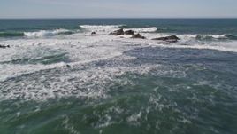 5K aerial stock footage tilt to reveal rock formations and fly out over ocean, Half Moon Bay, California Aerial Stock Footage | AXSF15_055