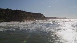 5K aerial stock footage of flying low over the ocean near cliffs, Half Moon Bay, California Aerial Stock Footage | AXSF15_060