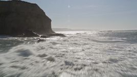 5K aerial stock footage of flying low over ocean waves near cliffs in Half Moon Bay, California Aerial Stock Footage | AXSF15_062