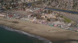5K aerial stock footage of tilting from the ocean to reveal roller coaster at Santa Cruz Beach Boardwalk, California Aerial Stock Footage | AXSF15_100