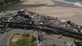 5K aerial stock footage of passing a roller coaster at Santa Cruz Beach Boardwalk, Santa Cruz, California Aerial Stock Footage | AXSF15_104