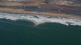 5K aerial stock footage of flying by waves rolling toward a beach, Moss Landing, California Aerial Stock Footage | AXSF15_112