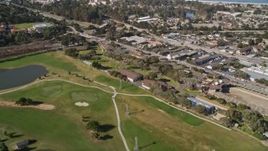 5K aerial stock footage tilt from golf course to reveal coastal neighborhoods on the Monterey Peninsula, Monterey, California Aerial Stock Footage | AXSF16_002
