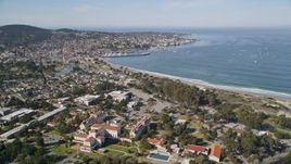 5K aerial stock footage tilt from highway interchange, reveal US Naval Postgraduate School and coastal community in Monterey, California Aerial Stock Footage | AXSF16_003