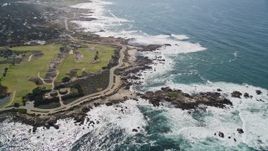 5K aerial stock footage of Pacific Grove Municipal Golf Links and waves crashing on the coast by Ocean View Boulevard, Pacific Grove, California Aerial Stock Footage | AXSF16_014