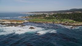5K aerial stock footage ocean waves rolling toward Cypress Point Golf Course, Pebble Beach, California Aerial Stock Footage | AXSF16_024