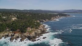 5K aerial stock footage of tilting from the ocean to reveal coastal mansions, Pebble Beach, California Aerial Stock Footage | AXSF16_025
