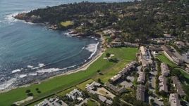 5K aerial stock footage of Pebble Beach Resorts hotel, tennis courts, and Pebble Beach Golf Links by Carmel Bay, Pebble Beach, California Aerial Stock Footage | AXSF16_031