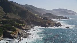 5K aerial stock footage of flying by waves crashing against jagged coastline, reveal Highway 1, Carmel, California Aerial Stock Footage | AXSF16_063
