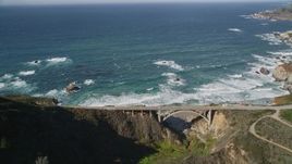 5K aerial stock footage of flying away from Rocky Creek Bridge above coastal cliffs, Carmel, California Aerial Stock Footage | AXSF16_068